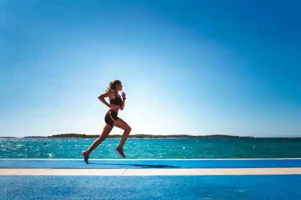 Woman running showing strong leg muscle Skegness